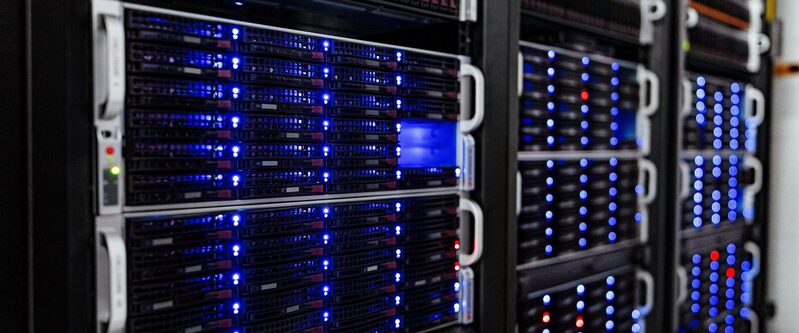 Rows of tidy server racks with blue status lights in a quiet computer room